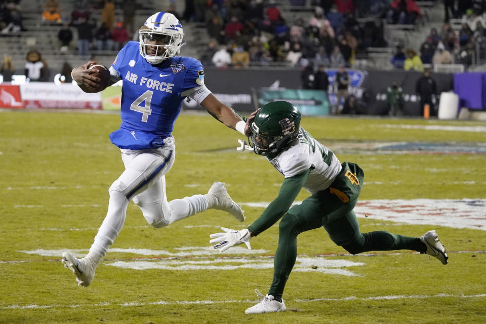 Air Force quarterback Haaziq Daniels (4) tried to fend off Baylor cornerback Tevin Williams III (27) during the first half of the Armed Forces Bowl NCAA college football game in Fort Worth, Texas, Thursday, Dec. 22, 2022. (AP Photo/LM Otero)
