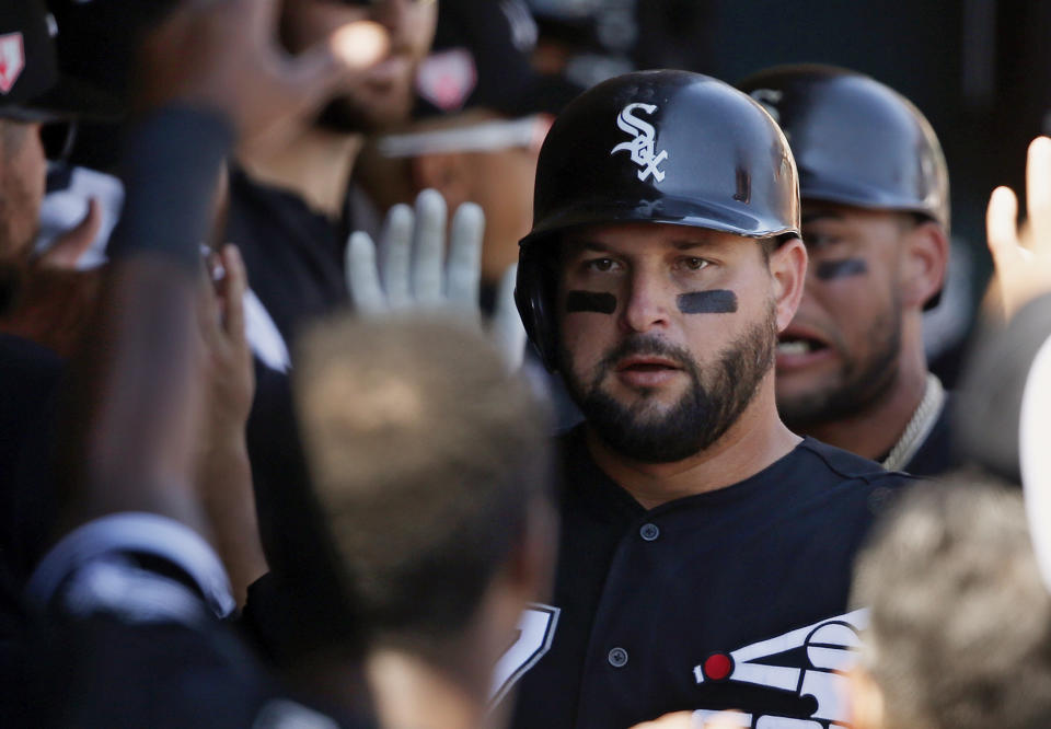 Chicago White Sox's Yonder Alonso is congratulated in the dugout following his two-run home run in the first inning of a spring training baseball game against the San Francisco Giants, Monday, March 18, 2019, in Glendale, Ariz. (AP Photo/Sue Ogrocki)