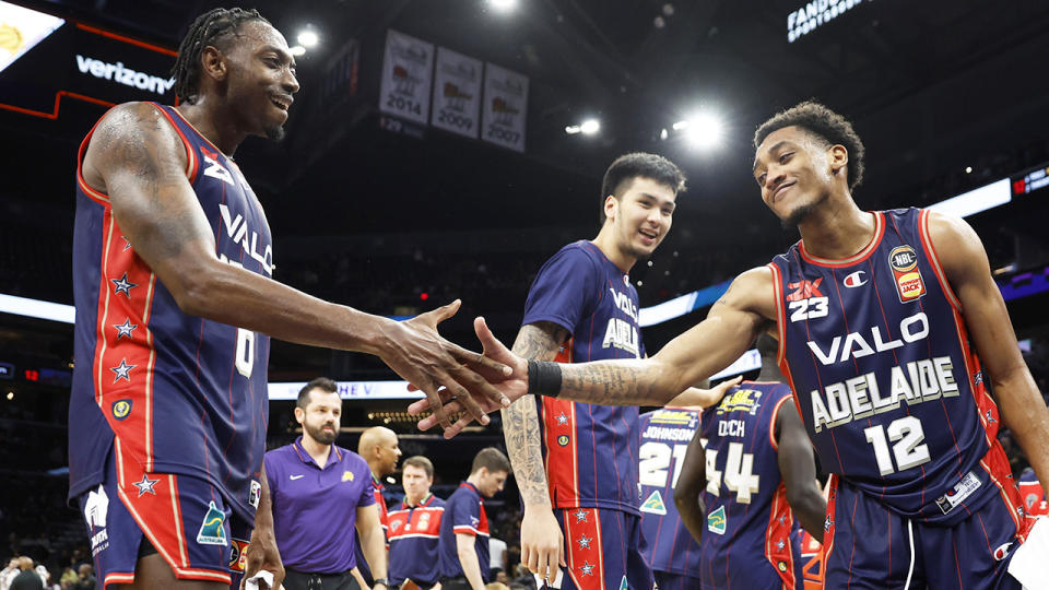 Adelaide 36ers players Craig Randall II and Robert Franks hi-five after beating the NBA's Phoenix Suns.