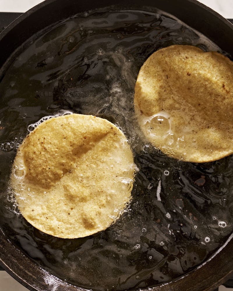 someone frying tostadas in oil