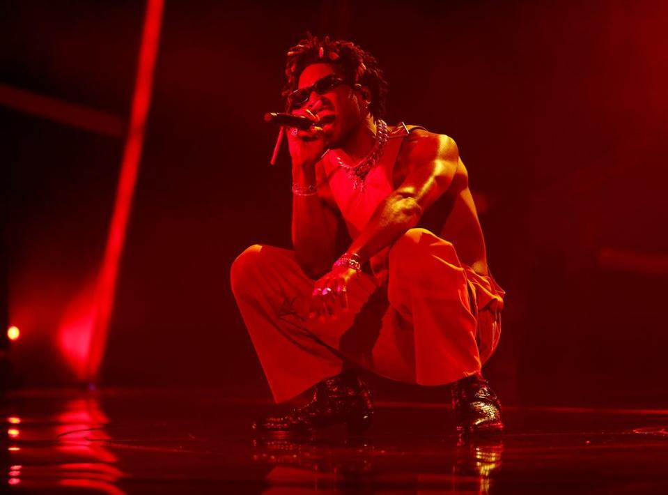 SAINt JHN crouches during his performance.