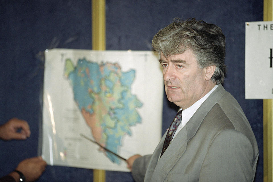 FILE - In this Aug. 25, 1992 file photo, Radovan Karadzic, Bosnian Serb leader in Bosnia-Herzegovina, indicates the Serb territories in Yugoslavia during a news conference in London. Nearly a quarter of a century since Bosnia’s devastating war ended, former Bosnian Serb leader Radovan Karadzic is set to hear the final judgment on whether he can be held criminally responsible for unleashing a wave of murder and destruction during Europe’s bloodiest carnage since World War II. United Nations appeals judges on Wednesday March 20, 2019, will decide whether to uphold or overturn Karadzic’s 2016 convictions for genocide, crimes against humanity and war crimes and his 40-year sentence. (AP Photo/Denis Paquin, File)