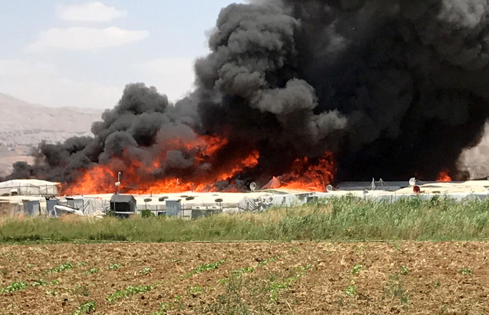 <p>Smoke rises after fire breaks out due to an unknown reason at the Qob Elias refugee camp at the Beqaa valley in Lebanon on July 1, 2017. (Hasan Jarrah/Anadolu Agency/Getty Images) </p>