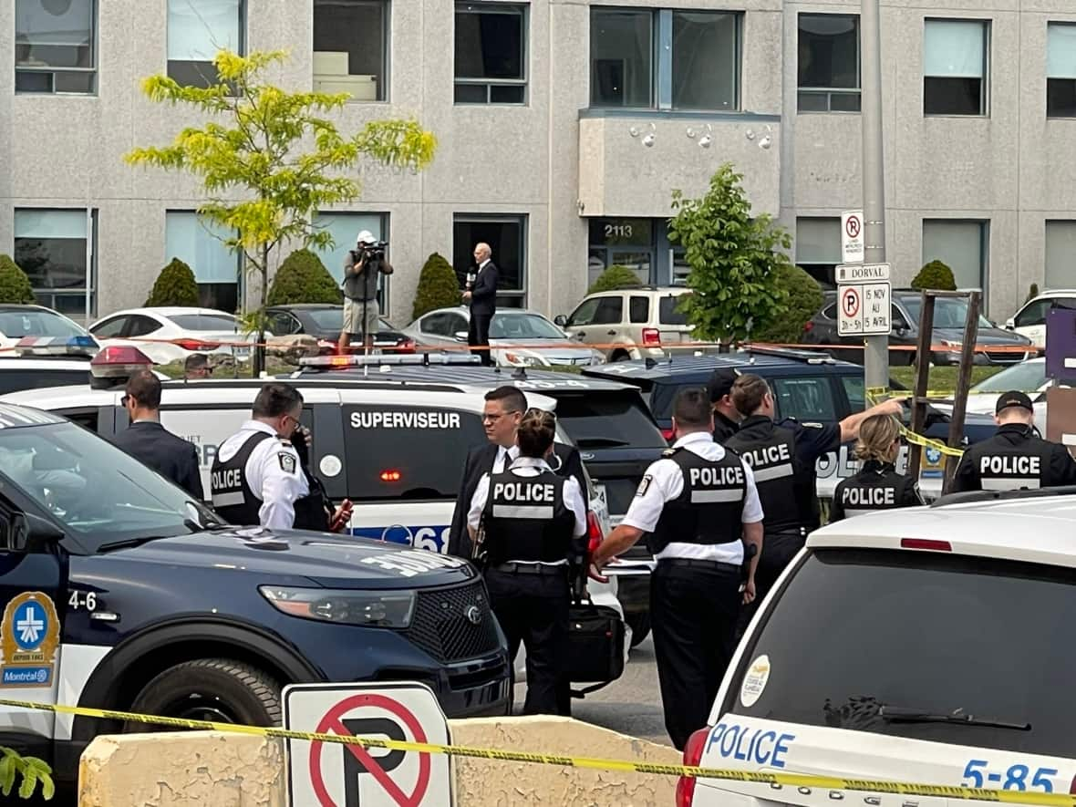 Police descended on a parking lot in Dorval, Que., on Monday, where Francesco Del Balso was shot and killed.  (Pascal Robidas/Radio-Canada - image credit)