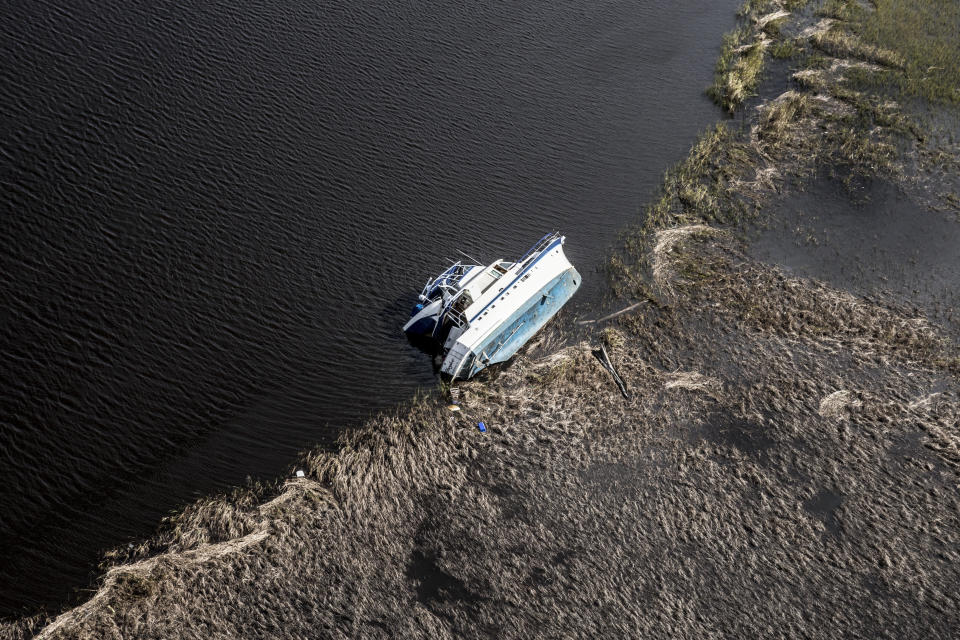 A boat lies capsized on the Cape Fear River in Wilmington.&nbsp;