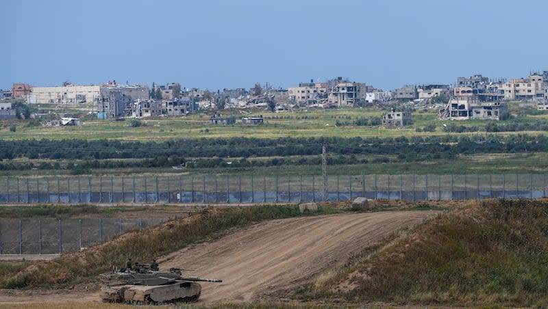 Israeli soldiers rest on top of their tank on the border with the Gaza Strip, in southern Israel, Monday, April 8, 2024.