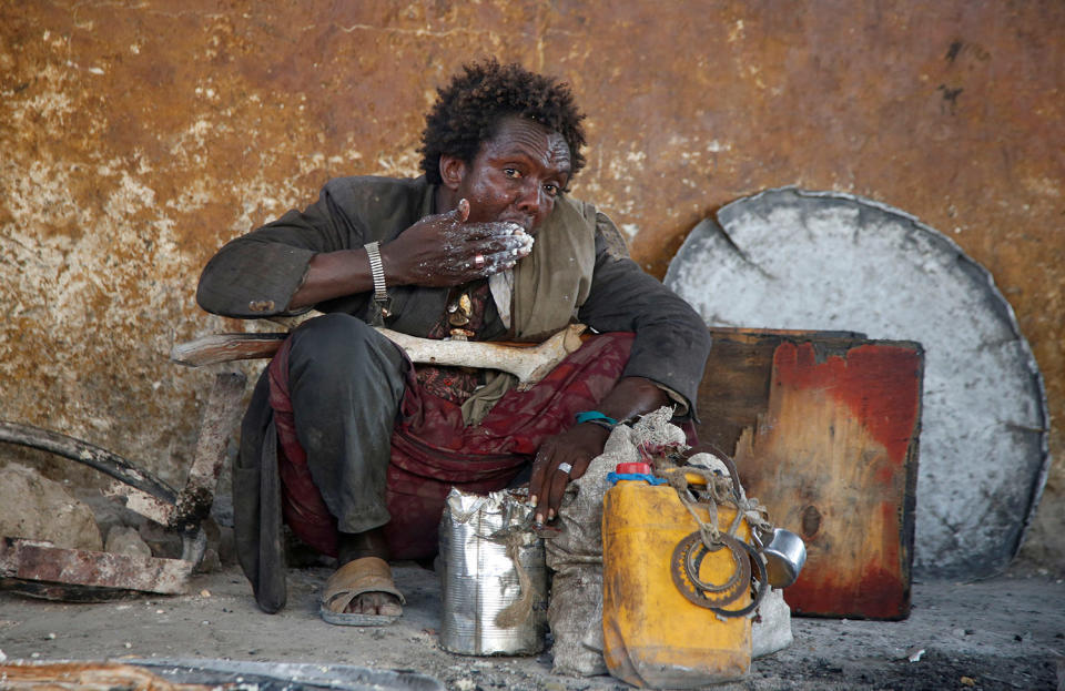 Displaced Somali man eats a maize meal