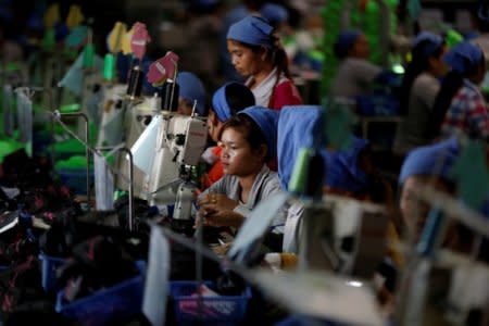Women work on the production line at Complete Honour Footwear Industrial, a footwear factory owned by a Taiwan company, in Kampong Speu, Cambodia, July 4, 2018. REUTERS/Ann Wang