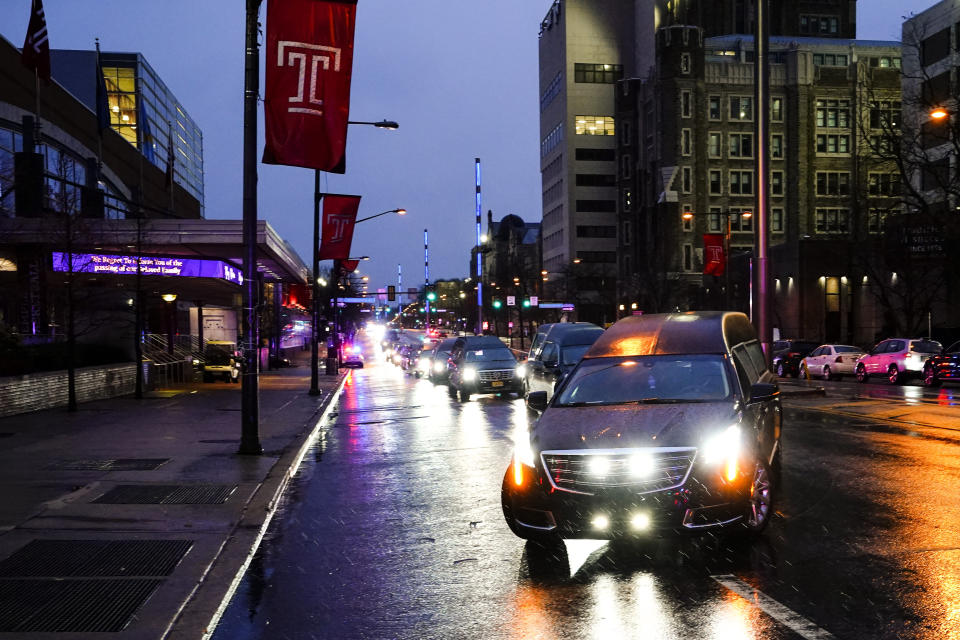 The funeral procession the victims of a deadly row house fire arrive for services at Temple University in Philadelphia, Monday, Jan. 17, 2022. Officials say it's the city's deadliest single fire in at least a century. (AP Photo/Matt Rourke)