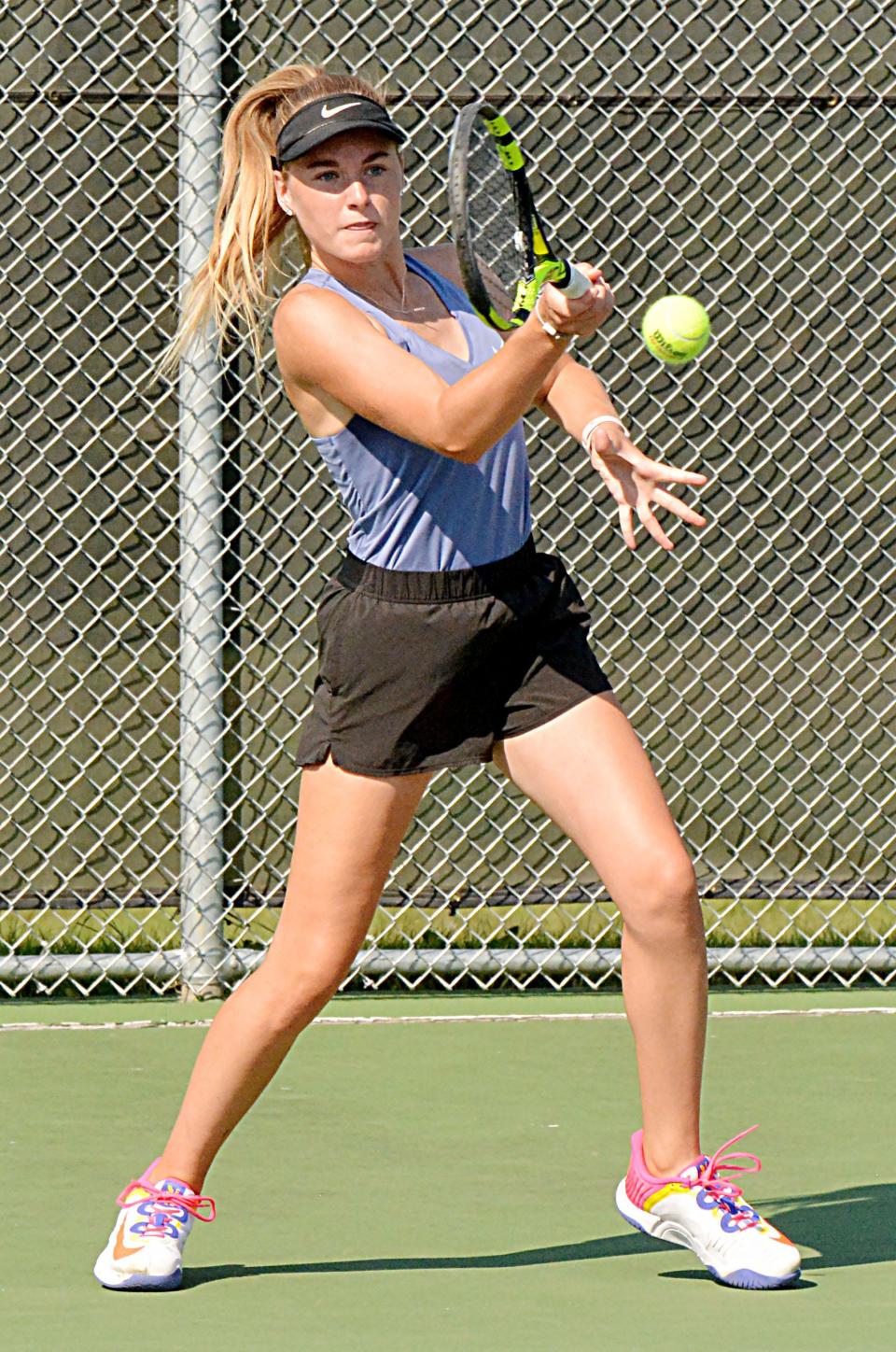 Watertown's Josie Heyn clubs a forehand return during Tuesday's high school girls tennis dual at the Highland Park Courts.