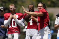 Dallas Cowboys quarterback Cooper Rush, left, and quarterback Dak Prescott (4) watch Los Angeles Chargers quarterback Justin Herbert, right, throw during a combined NFL practice at the Los Angeles Rams' practice facility in Costa Mesa, Calif. Thursday, Aug. 18, 2022. (AP Photo/Ashley Landis)