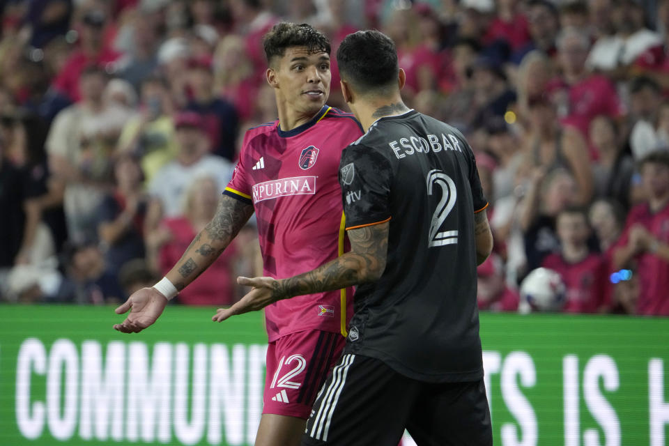 St. Louis City's Celio Pompeu (12) argues with Houston Dynamo's Franco Escobar (2) during the second half of an MLS soccer match Saturday, June 3, 2023, in St. Louis. (AP Photo/Jeff Roberson)