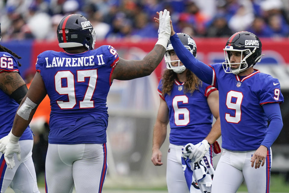 New York Giants place kicker Graham Gano (9) is congratulated by New York Giants defensive tackle Dexter Lawrence (97) after kicking a field goal Chicago Bears during the third quarter of an NFL football game, Sunday, Oct. 2, 2022, in East Rutherford, N.J. (AP Photo/Seth Wenig)