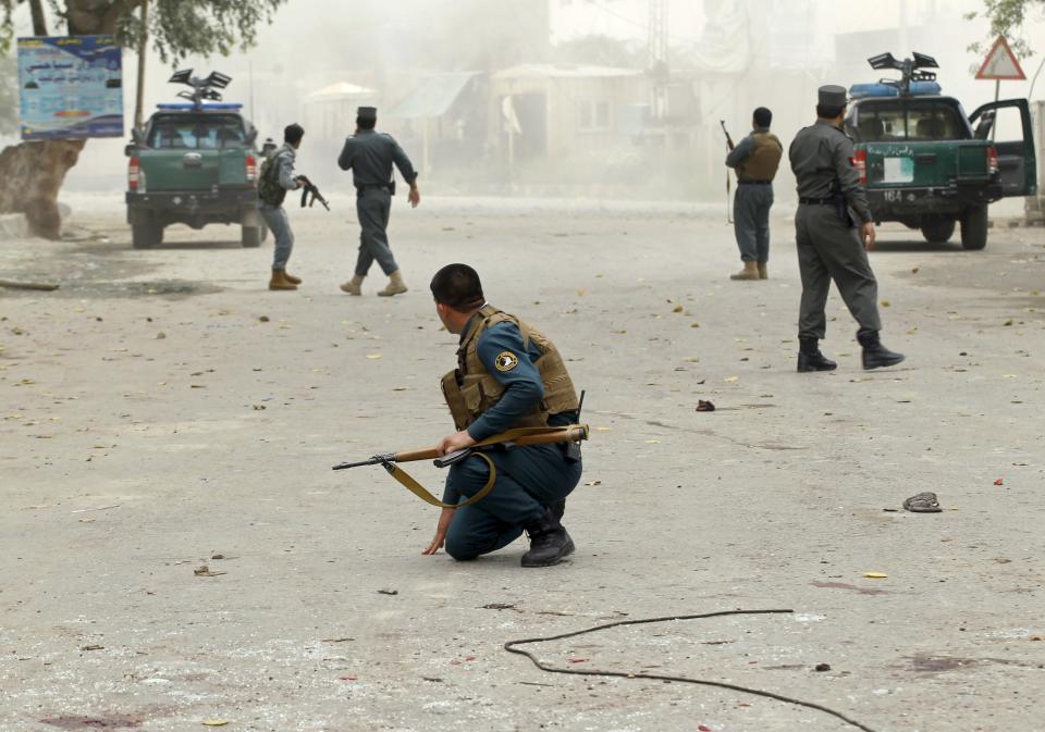 Policemen keep watch at a site after a third explosion in Jalalabad April 18, 2015. (REUTERS/Parwiz)