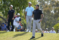 Phil Mickelson, right, watches his shot from the 12th tee with Xander Schauffele, left, and Max Homa during the first round of the U.S. Open Golf Championship, Thursday, June 17, 2021, at Torrey Pines Golf Course in San Diego. (AP Photo/Marcio Jose Sanchez)