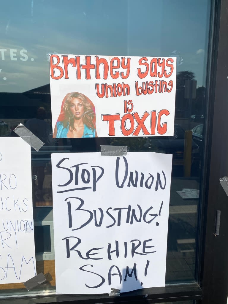 Signs in support of fired Starbucks worker Sam Amato. 