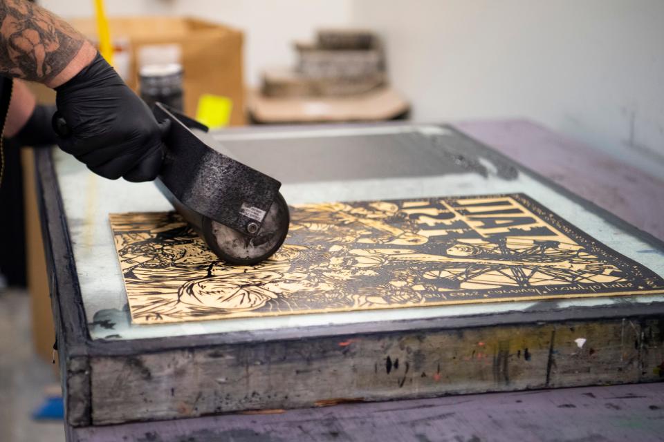 Local artist, author and educator Kyle Darnell applies ink to make a linocut print featured in his new book “Evansville Monsters II: The Book of Dark Days and Other Weird Tales” at the Univeristy of Evansville printmaking studio Tuesday, Nov. 21, 2023.
