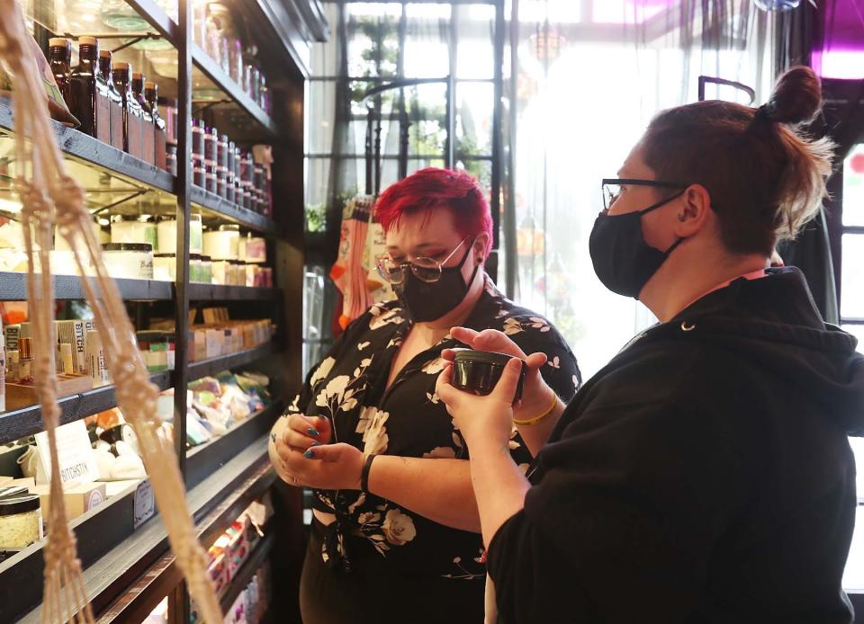 Allie Kennepohl, left, and her friend Marshall Hock, both of central Pennsylvania, shop at Gypsy Grace and the Vintage Goat in Akron in this file photo from 2021.