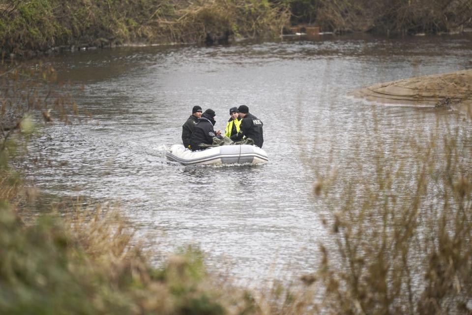 Officers on the River Wyre, in St Michael’s on Wyre, Lancashire, as police continue their search (PA Wire)