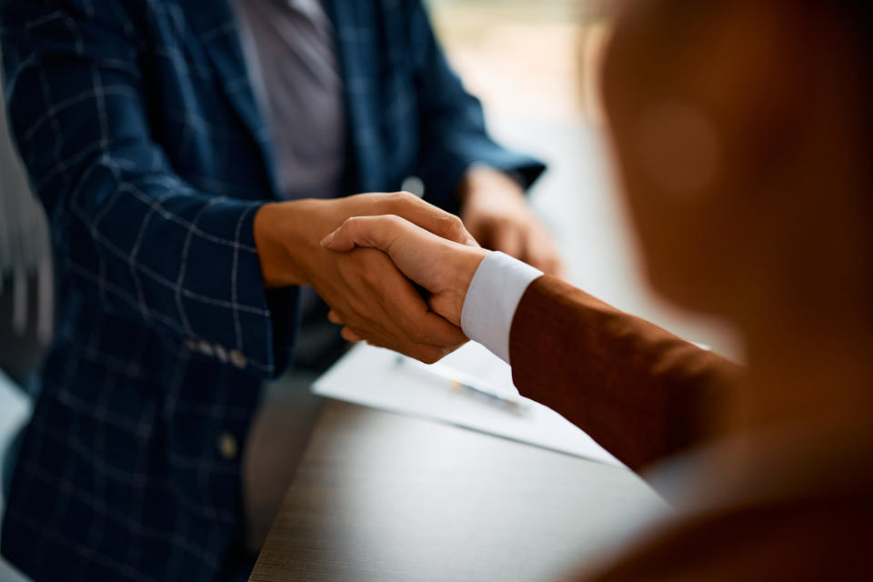 Two professionals engaging in a handshake, possibly after agreement or meeting