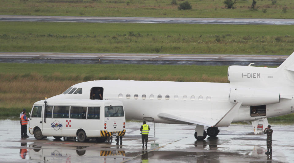 A man who appears to be Italian fugitive Cesare Battisti enters the cabin door of a plane before it takes off for Italy, where he will serve a life sentence, at the airport in Santa Cruz, Bolivia, Sunday, Jan. 13, 2019. Battisti escaped from an Italian prison in 1981 while awaiting trial on four counts of murder allegedly committed when he was a member of the Armed Proletarians for Communism. (AP Photo)