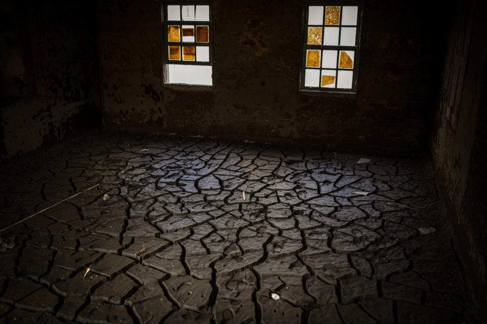 A house of the old village of Aceredo, submerged three decades ago when a hydropower dam flooded the valley, is photographed emerged due to drought at the Lindoso reservoir, in northwestern Spain, Friday, Feb. 11, 2022. Large sections of Spain are experiencing extreme or prolonged drought, with rainfall this winter at only one-third of the average in recent years. The situation is similar in neighboring Portugal, where 45% of the country is now enduring “severe” or “extreme” drought. (AP Photo/Emilio Morenatti)