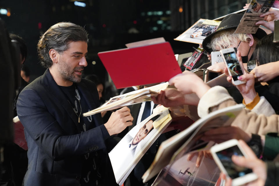 TOKYO, JAPAN - DECEMBER 11: Oscar Isaac signs autographs for fans at the special fan event for 'Star Wars: The Rise of Skywalker' at Roppongi Hills on December 11, 2019 in Tokyo, Japan. (Photo by Christopher Jue/Getty Images for Disney)