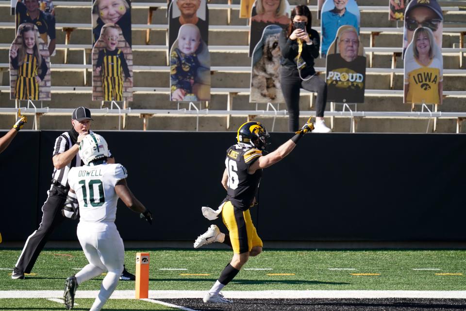 Iowa's Charlie Jones (16) scores a touchdown on a 54-yard punt return ahead of Michigan State's Michael Dowell (10) during the first half of an NCAA college football game, Saturday, Nov. 7, 2020, in Iowa City, Iowa.