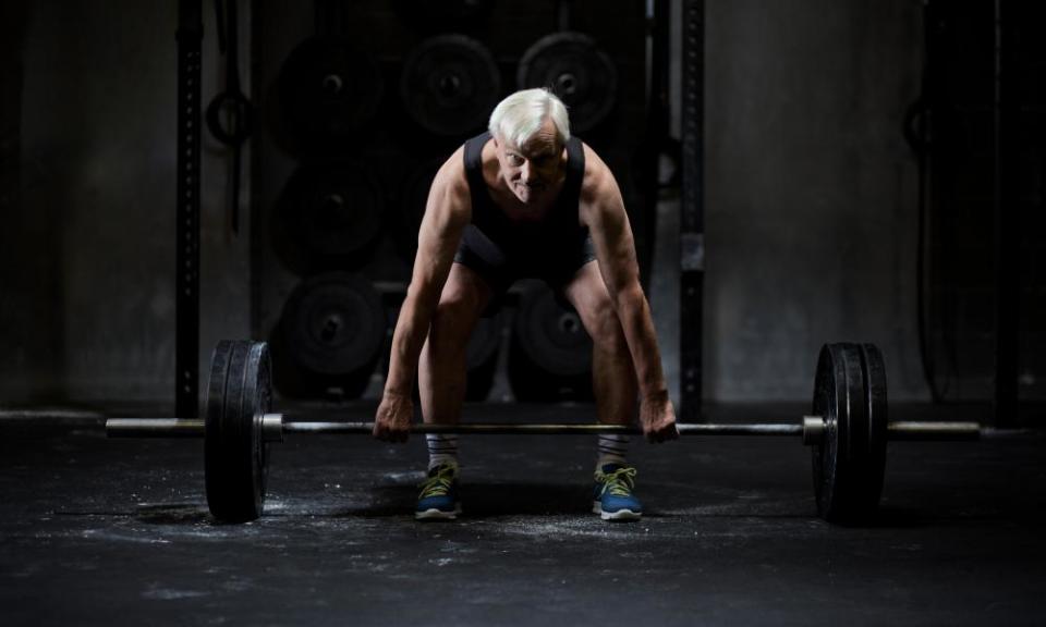 Man and barbell on gym