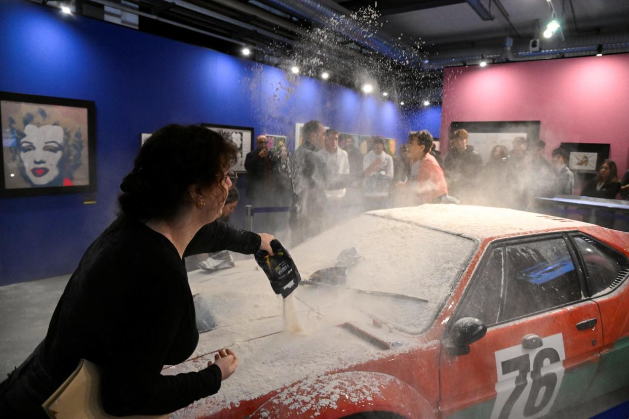 Climate activists of the Last Generation throw flour on Andy Warhol's work, in Milan, Italy, November 18, 2022.