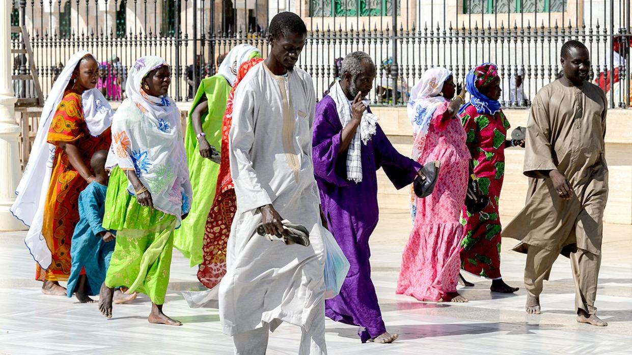 Senegalese people walk Great Mosque of Touba home of Mouride Brotherhood