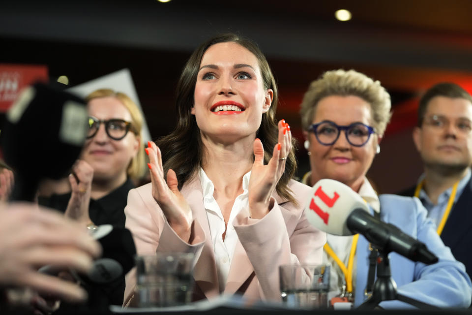 Finnish Prime Minister Sanna Marin, Social Democratic Party chair, center, reacts as she watches results of exit polls in Helsinki, Finland, Sunday, April 2, 2023. (AP Photo/Sergei Grits)