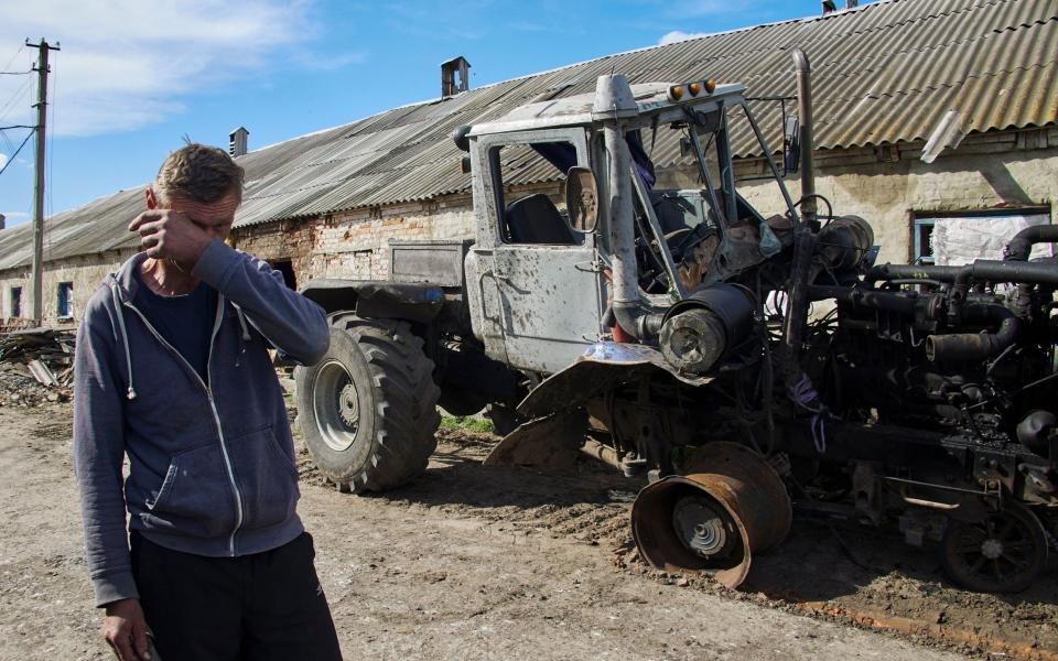  A local man reacts near his destroyed tractor on a farm in the village of Mala Rohan, near Kharkiv, Ukraine - SERGEY KOZLOV/EPA-EFE/Shutterstock 