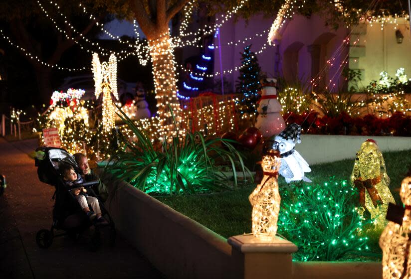 Torrance, California December 19, 2023-People walk by Christmas decorations along Reese Way in Torrance. (Wally Skalij/Los Angeles Times)