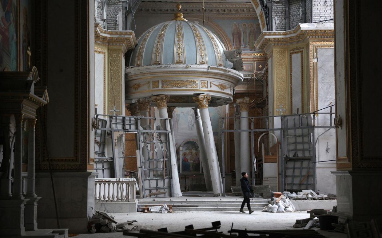 A worker repairs the Cathedral of the Transfiguration damaged as a result of Russian missile strike