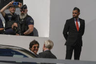 Tom Cruise, bottom centre, is greeted upon arrival at the photo call for the film 'Top Gun: Maverick', as securoty look on, at the 75th international film festival, Cannes, southern France, Wednesday, May 18, 2022. (AP Photo/Petros Giannakouris)