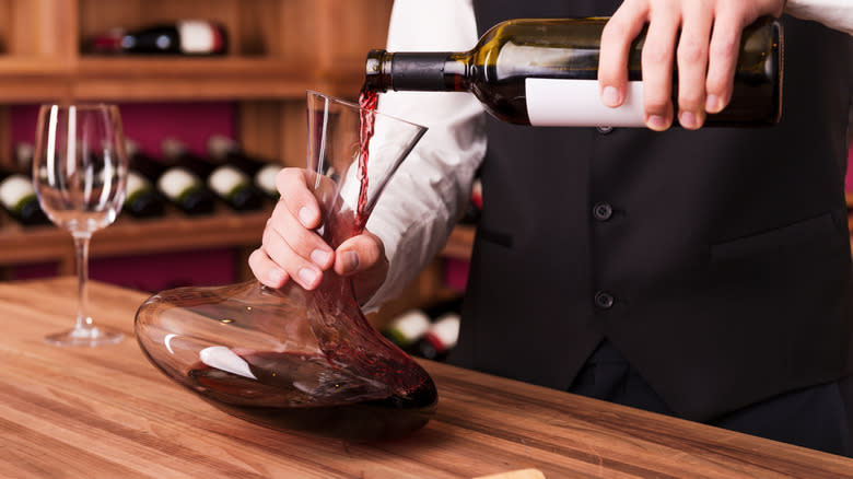 pouring wine into decanter