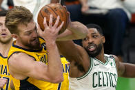Indiana Pacers forward Domantas Sabonis, front left, rebounds the ball against Boston Celtics forward Tristan Thompson in the second half of an NBA basketball game, Friday, Feb. 26, 2021, in Boston. (AP Photo/Elise Amendola)