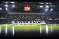 SC Freiburg fans display a banner with the inscription "Boycott Qatar" as a protest action against the World Cup in Qatar, ahead of the Bundesliga soccer match between Freiburg and FC Union Berlin at Europa-Park Stadion in Freiburg im Breisgau, Germany, Sunday, Nov. 13, 2022. . (Tom Weller/dpa via AP)