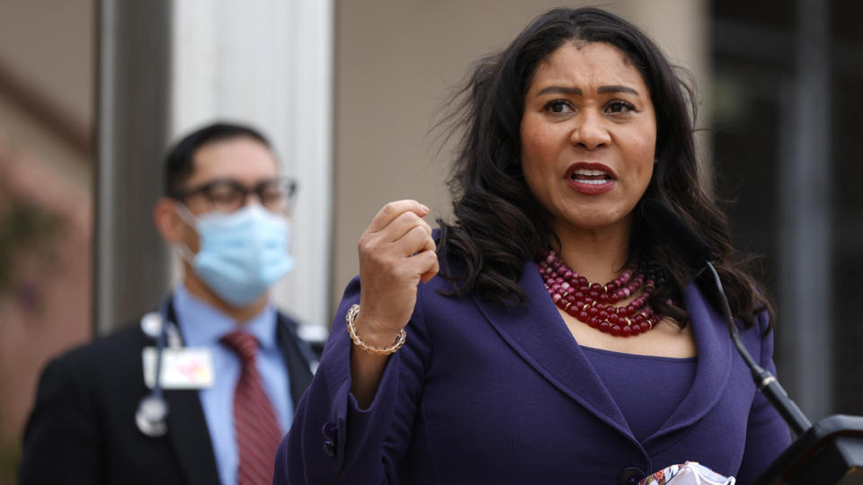 San Francisco Mayor London Breed, standing at a microphone, speaks during a news conference.