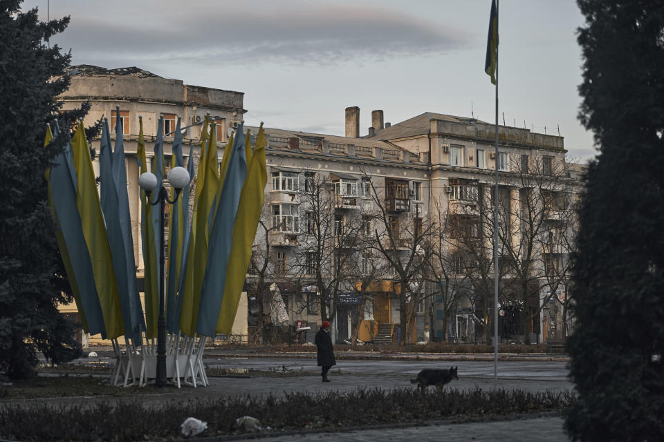 A lonely resident walks in the center of Bakhmut, the site of the heaviest battles with the Russian troops, in the Donetsk region, Ukraine, Friday, Dec. 9, 2022. (AP Photo/LIBKOS)