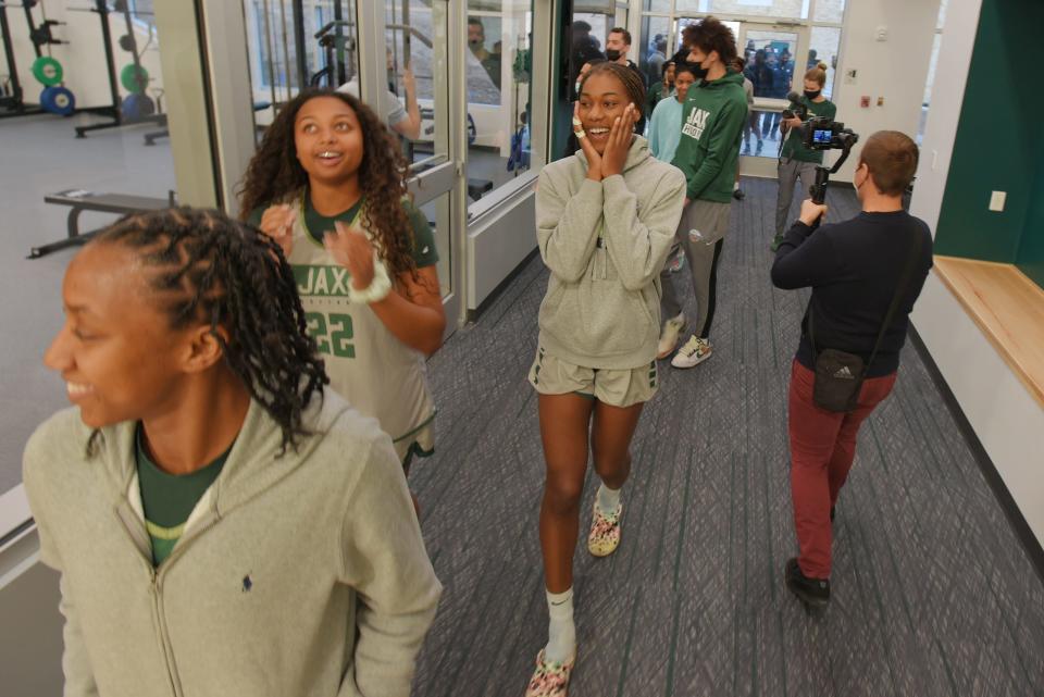 Jacksonville University basketball players Ashley Sneed (22) and Asiah Jones (with her hands to her face) as they walks through the doors of the school's new Basketball Performance Center on Jan. 25.