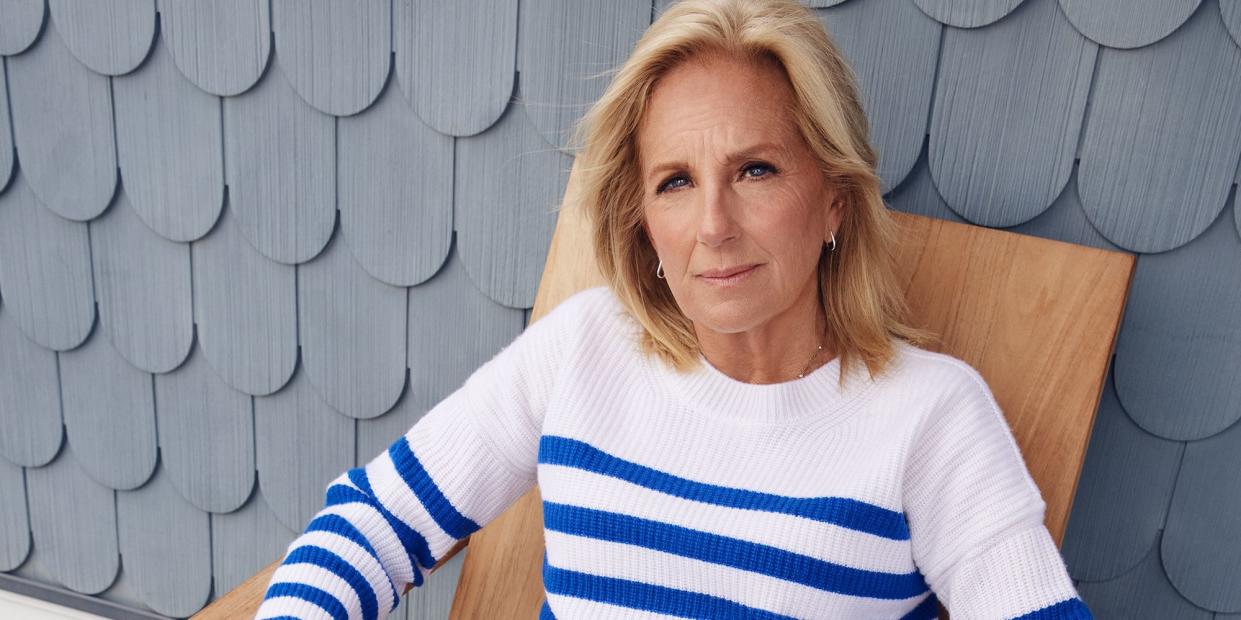 first lady jill biden sitting in a chair outside, looking at the camera