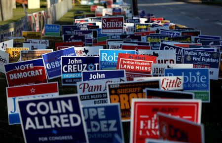 Campaign signs are seen outside a polling station on the last day of early voting in Dallas, Texas, U.S., November 2, 2018. REUTERS/Mike Segar/File Photo