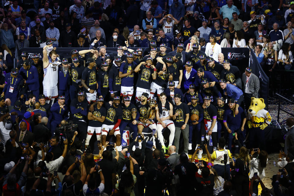 DENVER, COLORADO - JUNE 12: The Denver Nuggets pose for a team photo with the Larry O'Brien Championship Trophy after a 94-89 victory against the Miami Heat in Game Five of the 2023 NBA Finals to win the NBA Championship at Ball Arena on June 12, 2023 in Denver, Colorado. NOTE TO USER: User expressly acknowledges and agrees that, by downloading and or using this photograph, User is consenting to the terms and conditions of the Getty Images License Agreement. (Photo by Justin Edmonds/Getty Images)