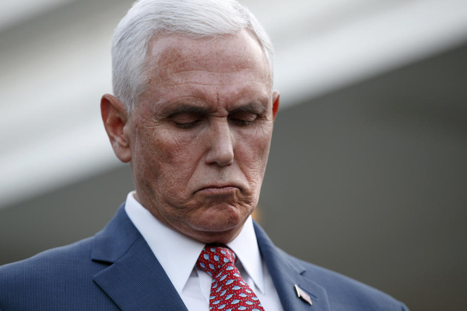 Vice President Mike Pence listens as Treasury Secretary Steven Mnuchin, speaks to reporters outside the West Wing of the White House, Monday, Oct. 14, 2019, in Washington. The U.S. is calling for an immediate ceasefire in Turkey's strikes against Kurds in Syria, and is sending Pence to lead mediation effort (AP Photo/Jacquelyn Martin)