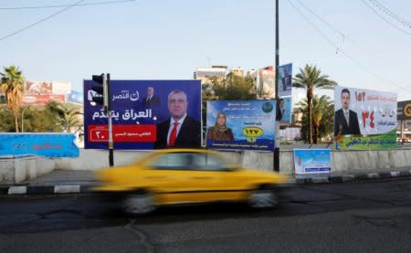 Campaign posters of local candidates are seen ahead of the parliamentary election, in Baghdad, Iraq, April 14, 2018. REUTERS/Khalid Al-Mousily
