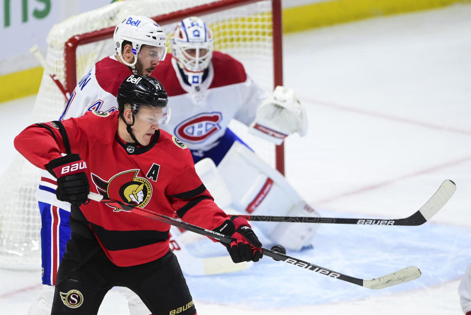 Ottawa Senators' Brady Tkachuk (7) deflects a shot toward Montreal Canadiens goalie Jake Allen (34) as Canadiens' Joel Edmundson (44) defends during the second period of an NHL hockey game Thursday, April 1, 2021, in Ottawa, Ontario. (Sean Kilpatrick/The Canadian Press via AP)