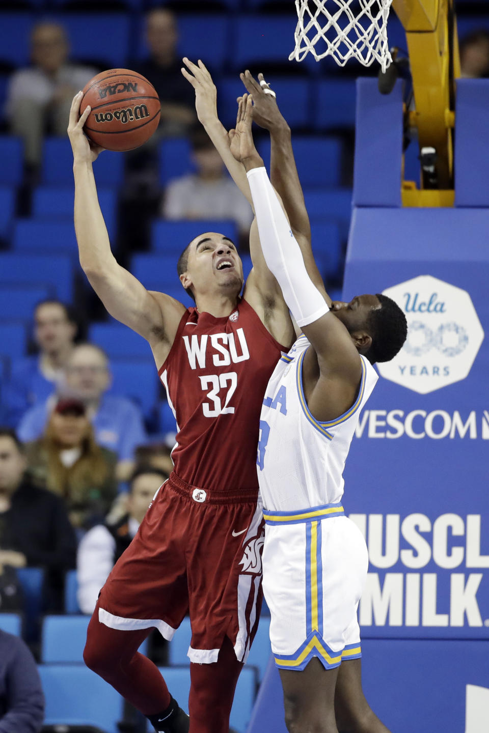 Washington State forward Tony Miller (32) shoots over UCLA guard Prince Ali during the first half of an NCAA college basketball game Thursday, Feb. 13, 2020, in Los Angeles. (AP Photo/Marcio Jose Sanchez)