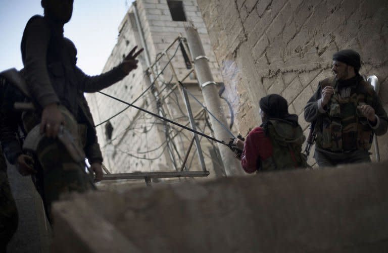 A rebel fighter launches a pipe bomb from a homemade slingshot into a building supposedly housing pro-government troops on February 16, 2013, in Deir Ezzor. The Observatory said the rebels lost five men in the eastern province of Deir Ezzor before taking control of the Kibar checkpoint, seizing weapons and ammunition and killing at least four soldiers